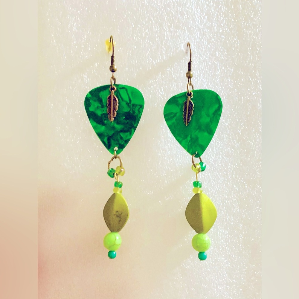 Green dangling guitar pick earrings